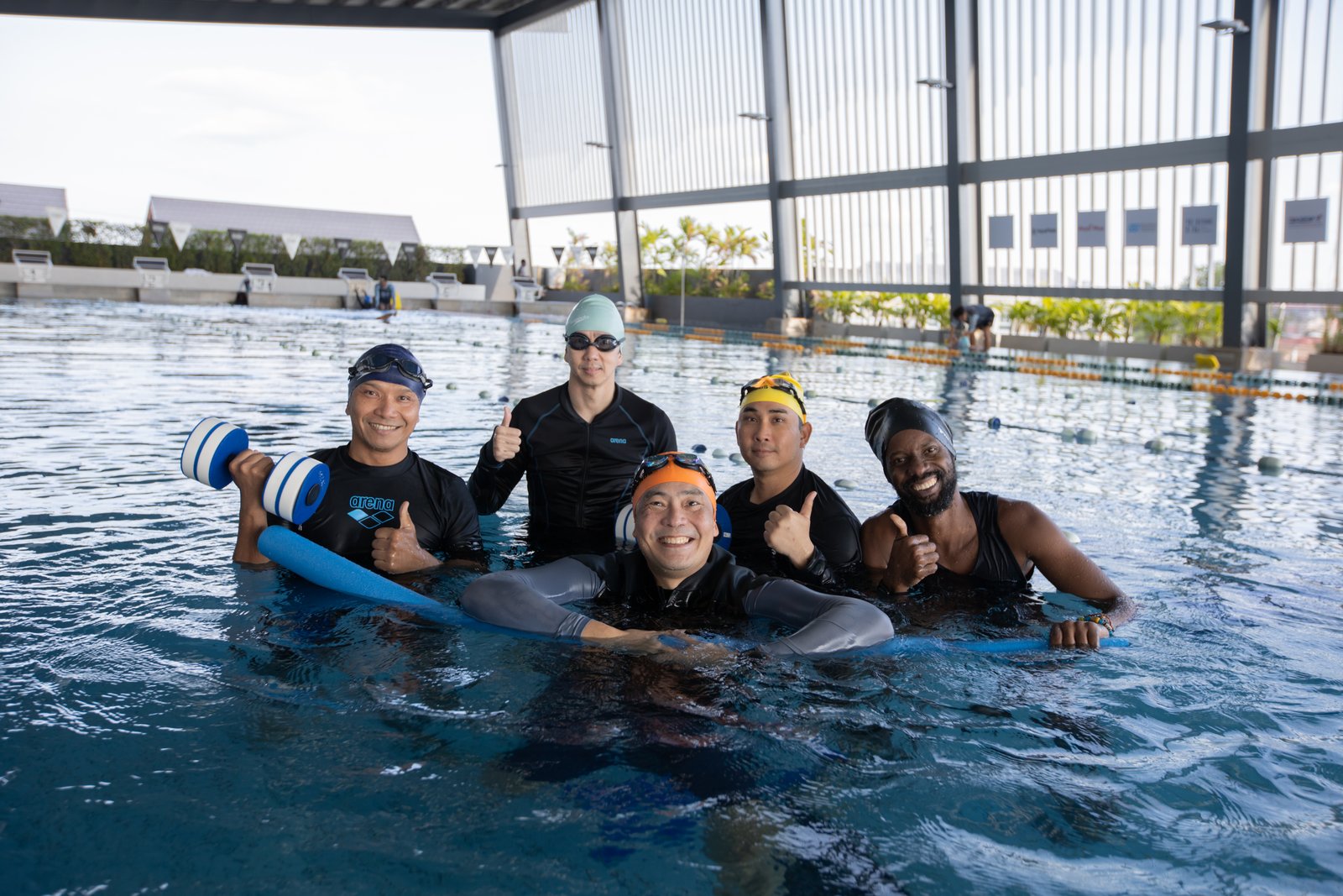 ผู้เข้าอบรมและโค้ชในสระระหว่างการฝึก · Trainees and coaches together in the pool