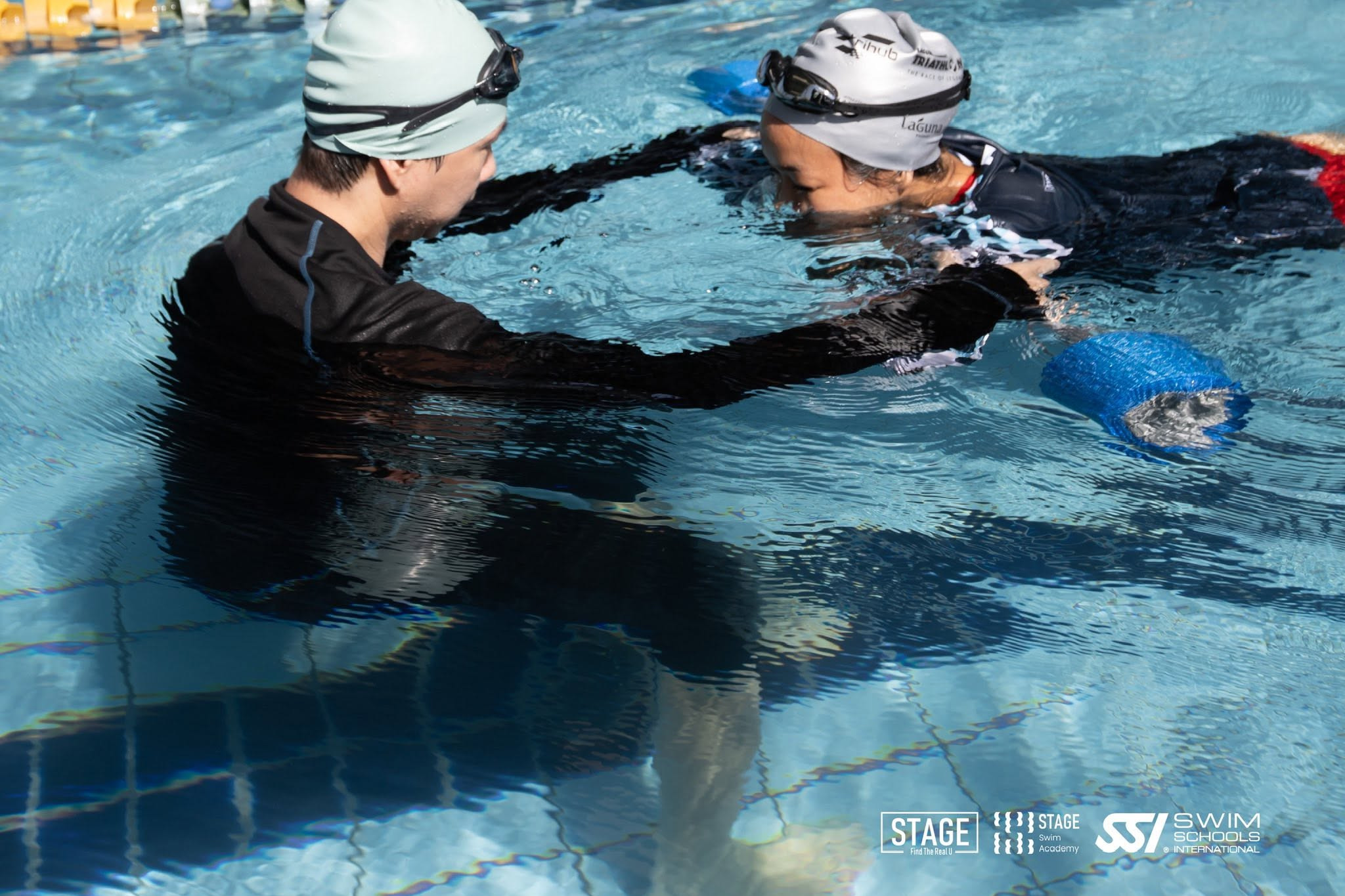 STAGE coach guiding a learner one-to-one in the pool
