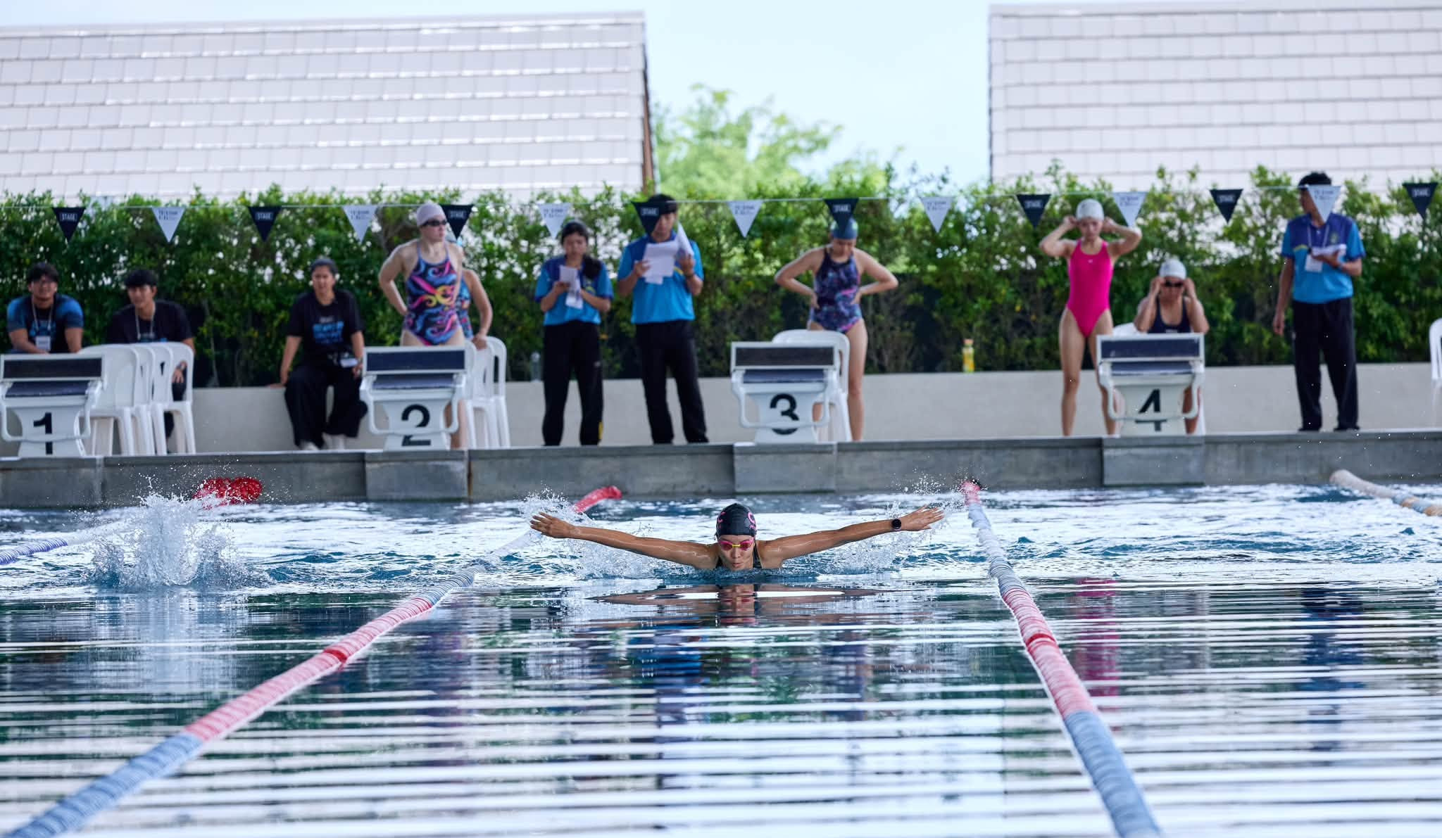 Swimmer racing butterfly in the STAGE pool